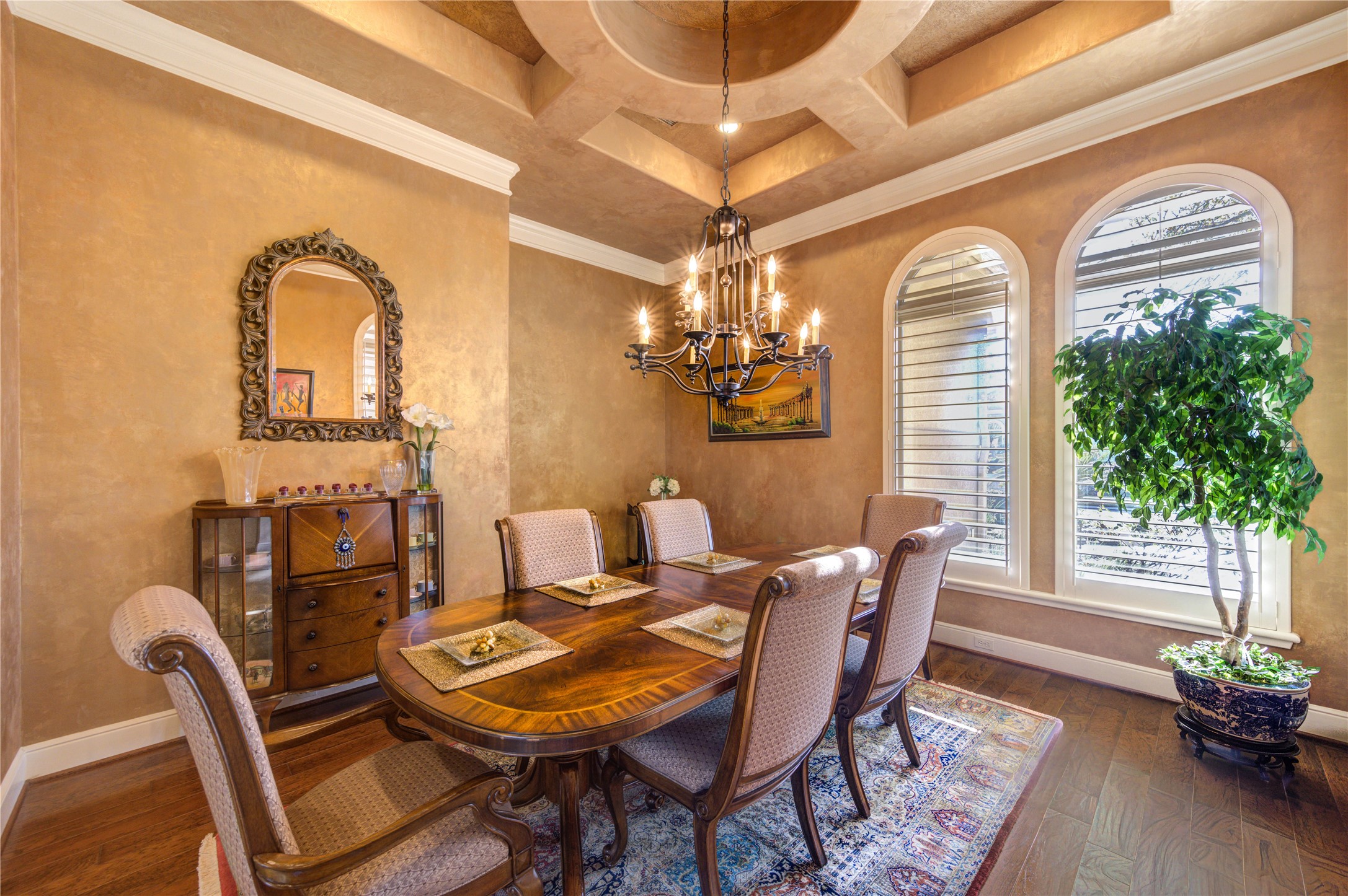 16618 Victoria Falls Lane Spring, TX 77379 - Photo 25 of 49 Elegant formal dining room featuring a stunning chandelier, rich hardwood floors, and large windows for natural light. Perfect for entertaining.