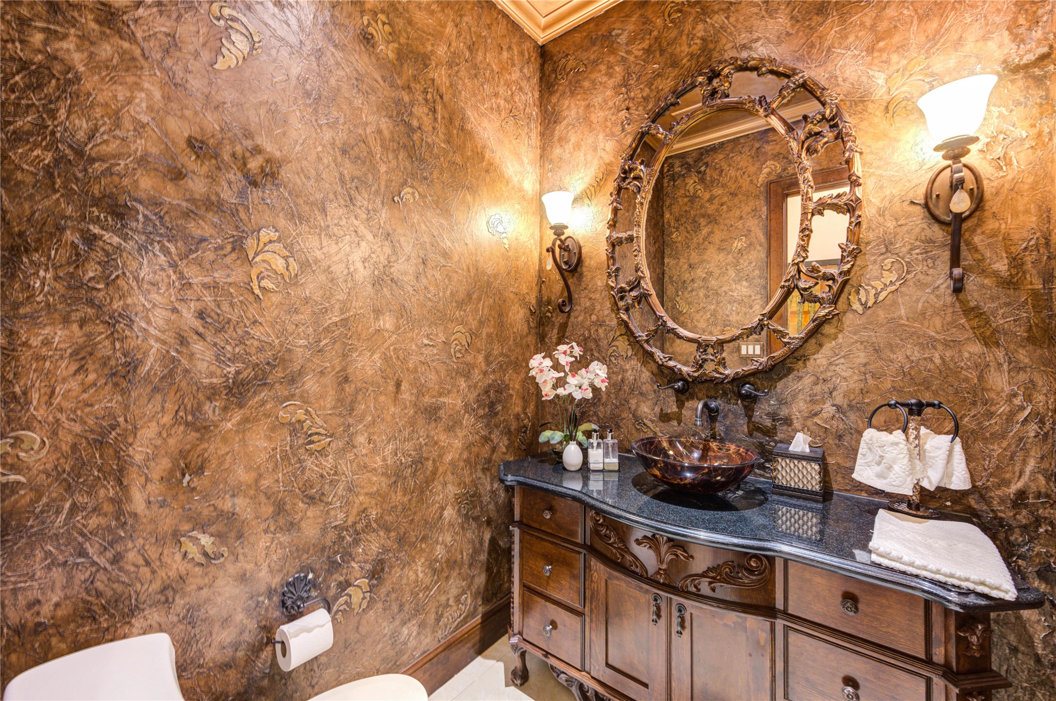 16618 Victoria Falls Lane Spring, TX 77379 - Photo 27 of 49 Luxurious powder room featuring elegant textured walls, a stunning ornate mirror, and sophisticated lighting, offering a refined touch to your home.