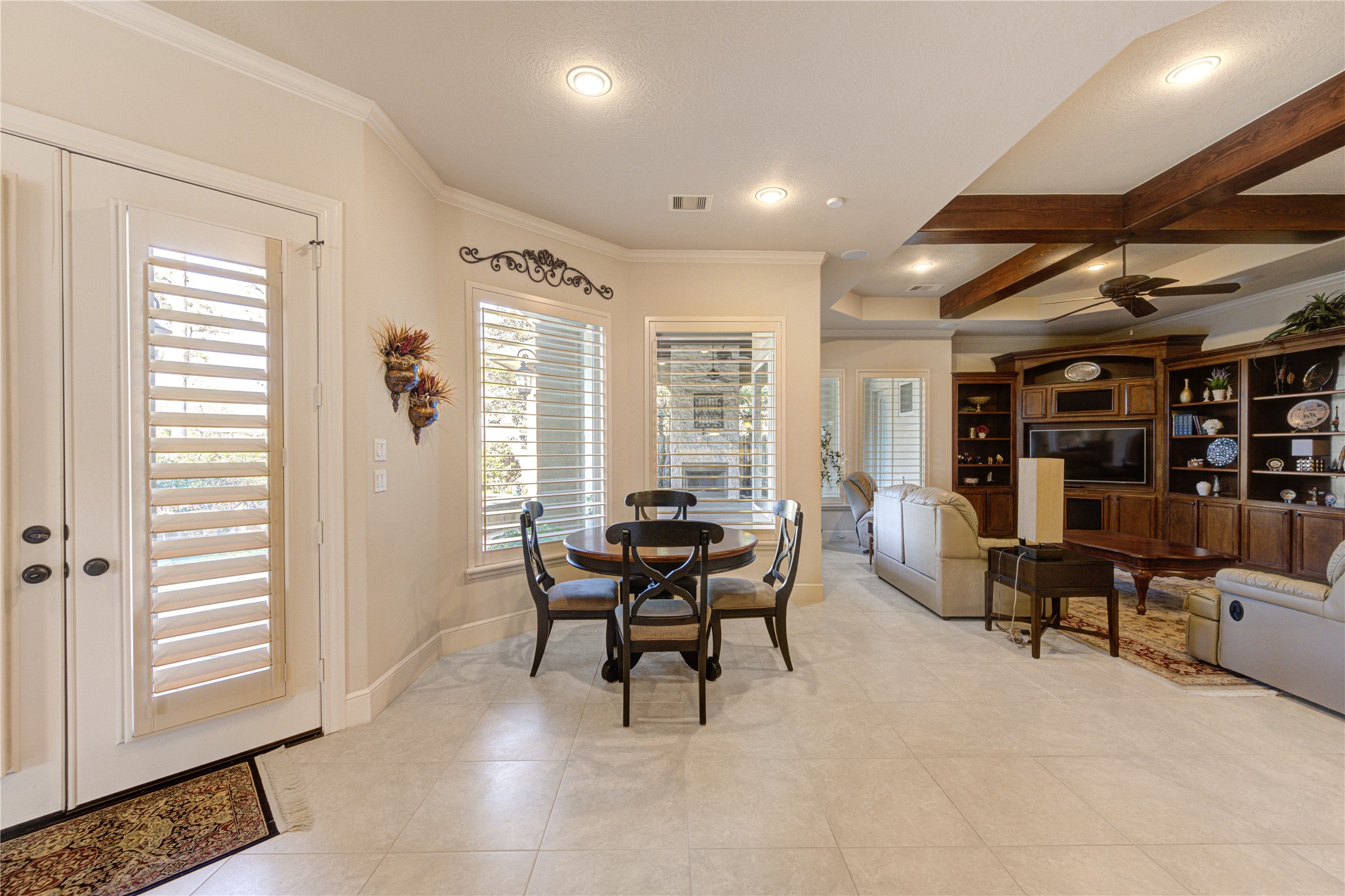 16618 Victoria Falls Lane Spring, TX 77379 - Photo 28 of 49 This inviting space, leading from the living room to the den, features elegant white cabinetry, sleek countertops, and cozy seating, offering both style and functionality.