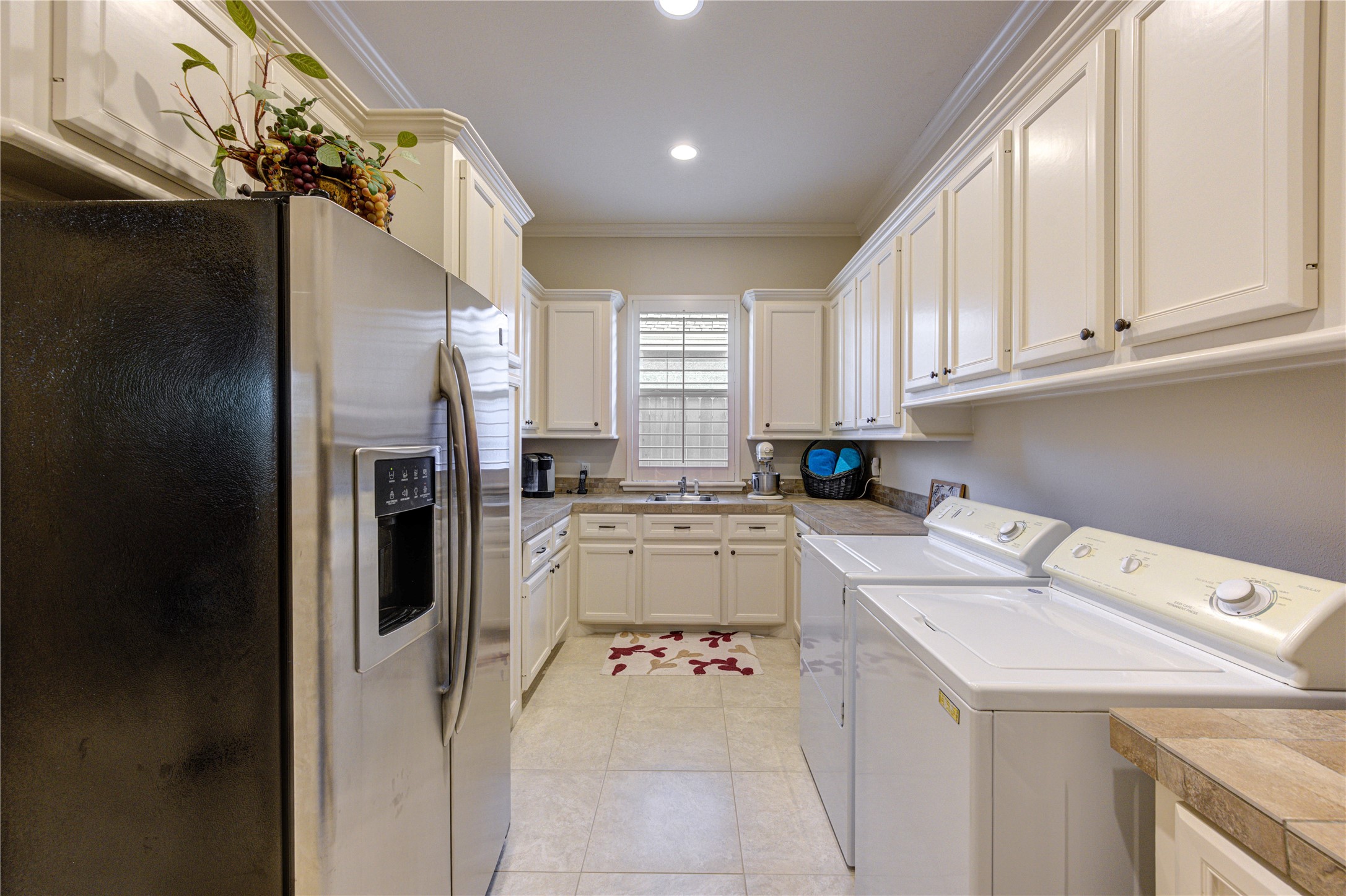 16618 Victoria Falls Lane Spring, TX 77379 - Photo 30 of 49 Spacious utility room featuring abundant storage, a convenient sink, and space for a refrigerator.
