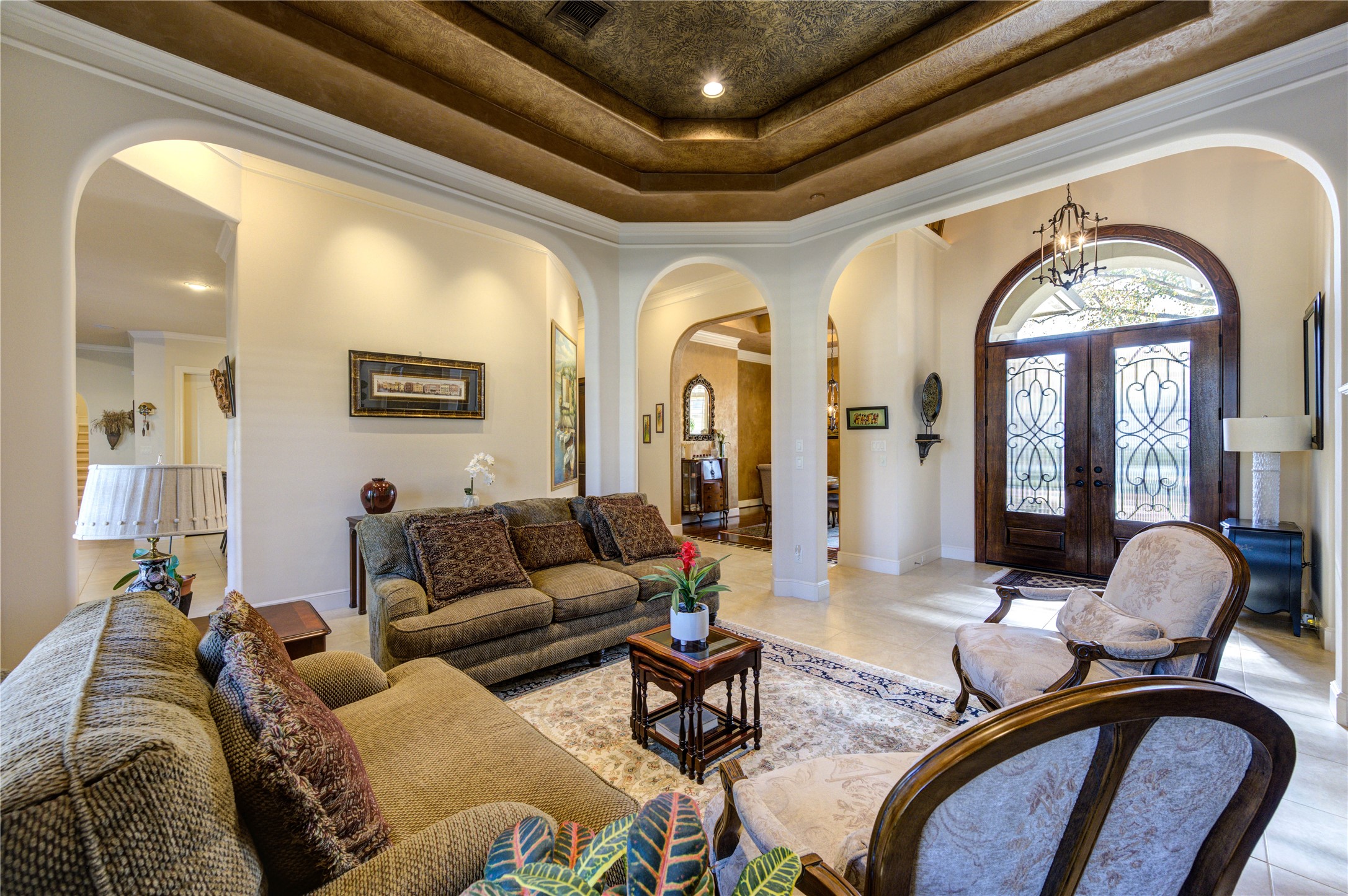 16618 Victoria Falls Lane Spring, TX 77379 - Photo 7 of 49 Experience timeless elegance with double French doors featuring intricate leaded glass, complemented by a trey ceiling and graceful arches.
