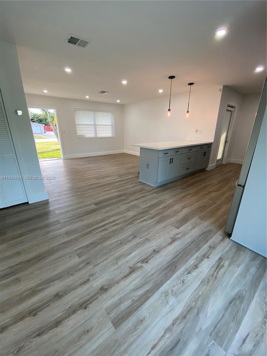 6829 Northwest 12th Street, Unit 6829 Plantation, FL 33313 - Photo 11 of 27 a view of kitchen and hall with wooden floor