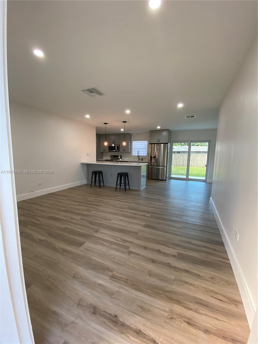 6829 Northwest 12th Street, Unit 6829 Plantation, FL 33313 - Photo 20 of 27 a view of a hall with wooden floor