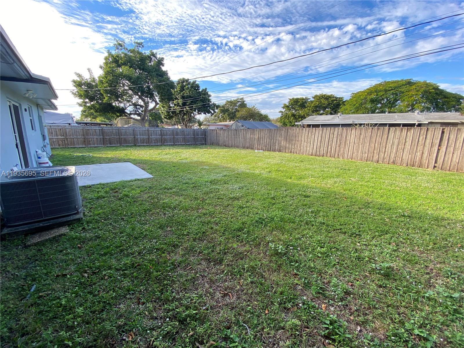 6829 Northwest 12th Street, Unit 6829 Plantation, FL 33313 - Photo 23 of 27 a view of a backyard with couches under an umbrella