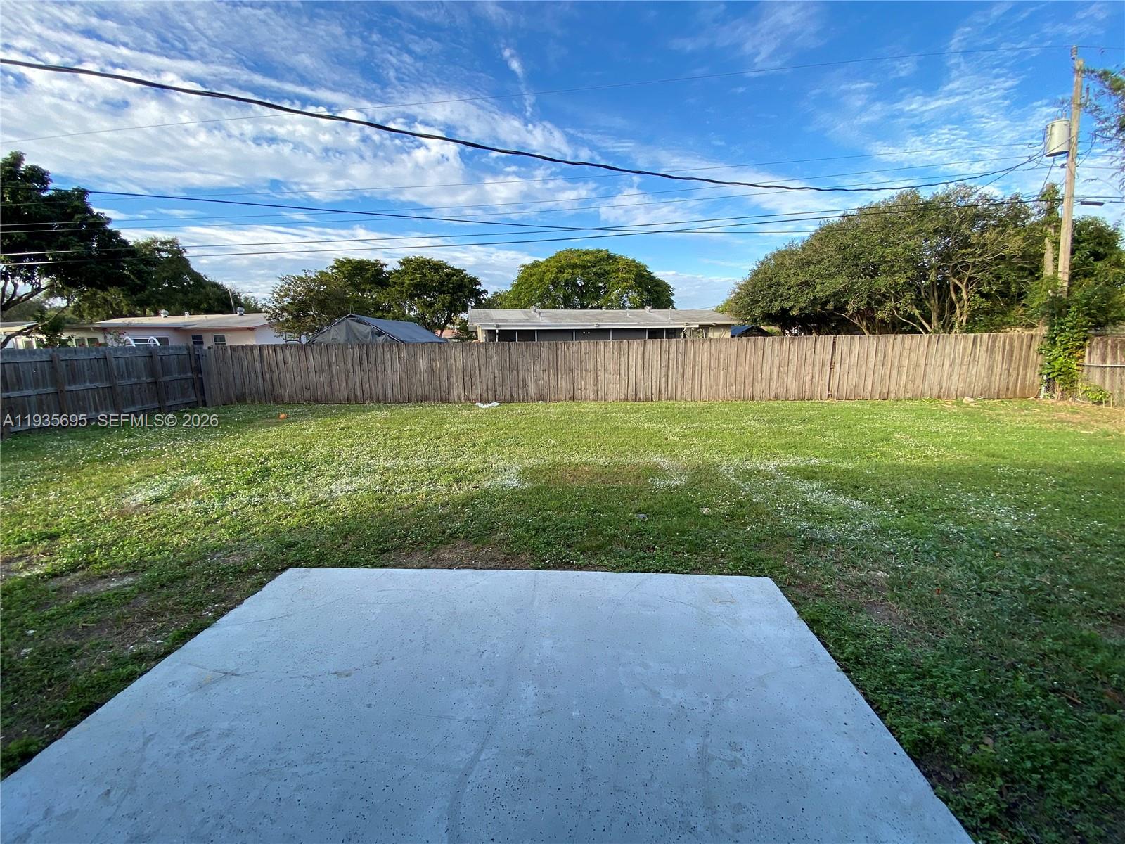 6829 Northwest 12th Street, Unit 6829 Plantation, FL 33313 - Photo 24 of 27 a view of a backyard with wooden fence