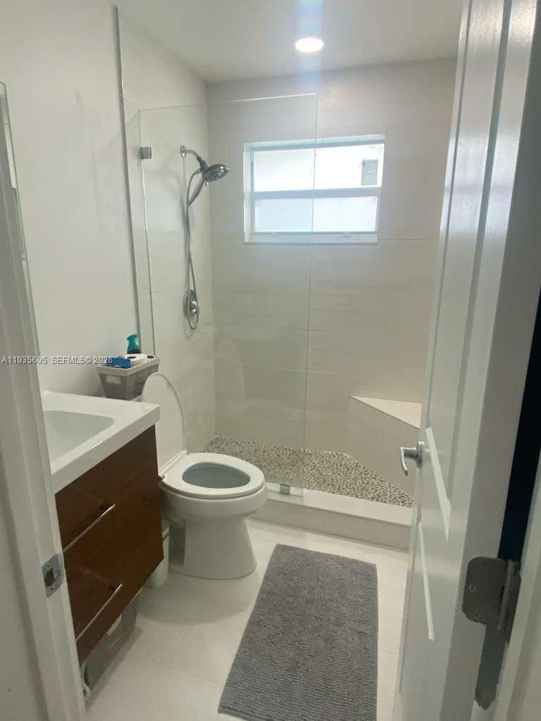 6829 Northwest 12th Street, Unit 6829 Plantation, FL 33313 - Photo 7 of 27 a bathroom with a sink a toilet and shower