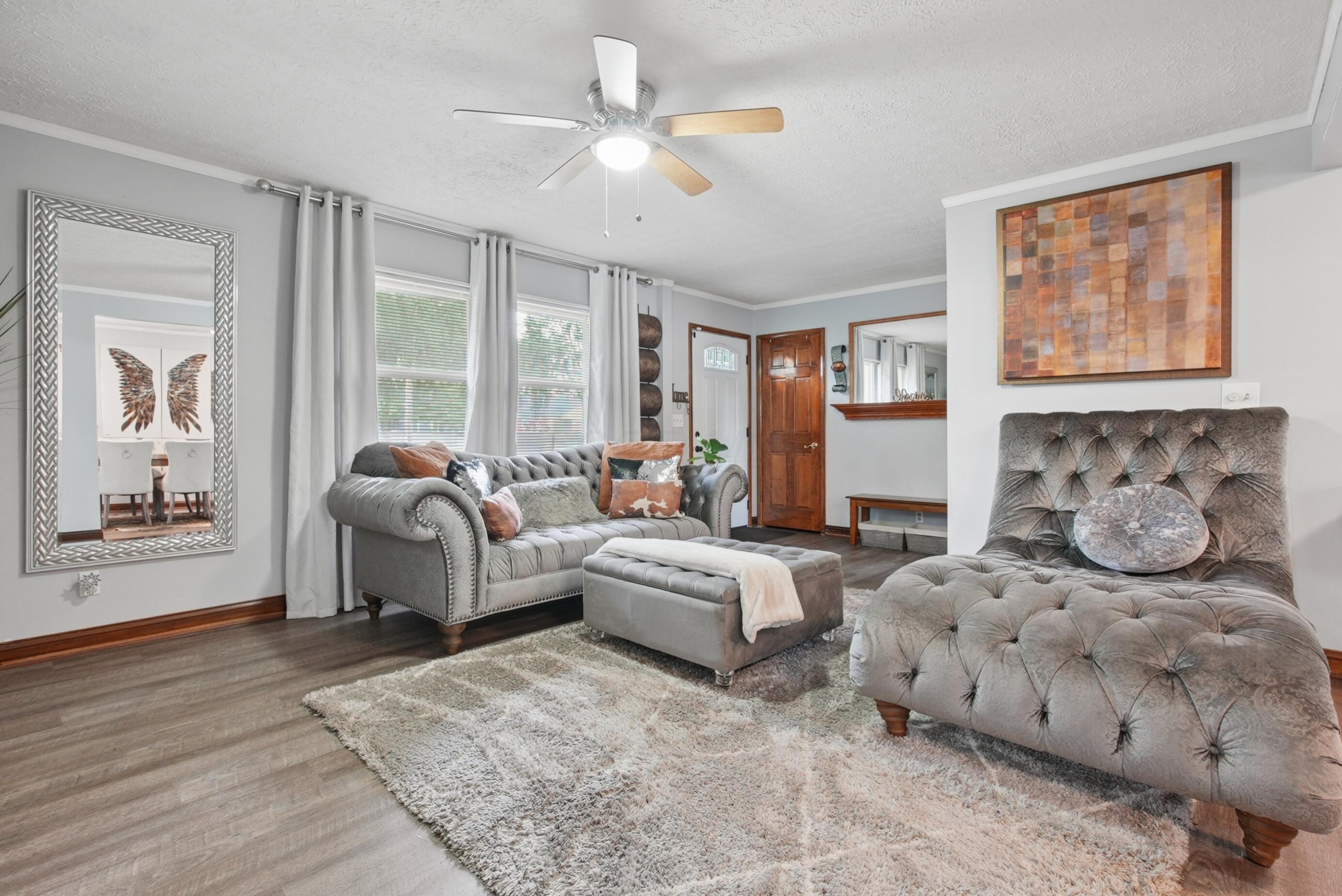 Natural light flows throughout the home from the picture window, numerous windows, and skylights in the kitchen and bath.