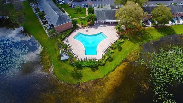 an aerial view of a house with outdoor space and pool