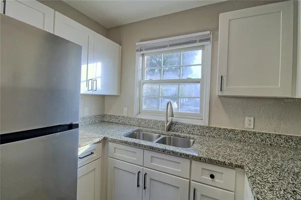 a kitchen with appliances cabinets and a window