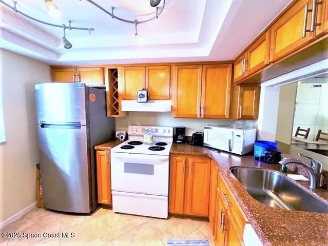 a kitchen with refrigerator a stove a washer and dryer