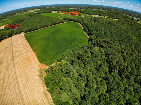 an aerial view of a golf course with a lake view