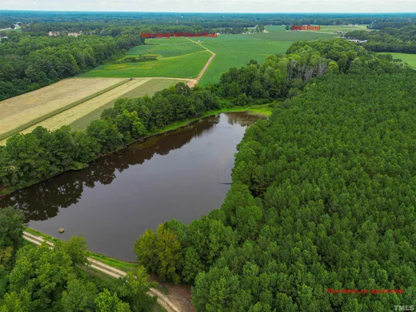 an aerial view of a house with a yard and lake view