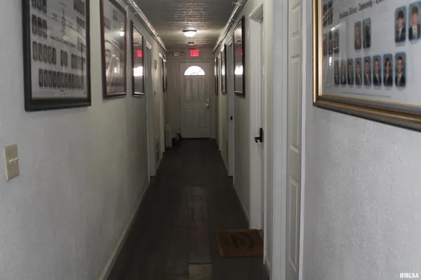 a hallway with stairs to other door