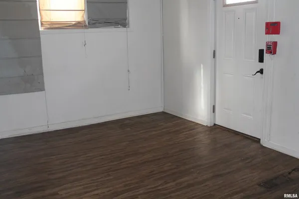 a view of small space with wooden floor and cabinet