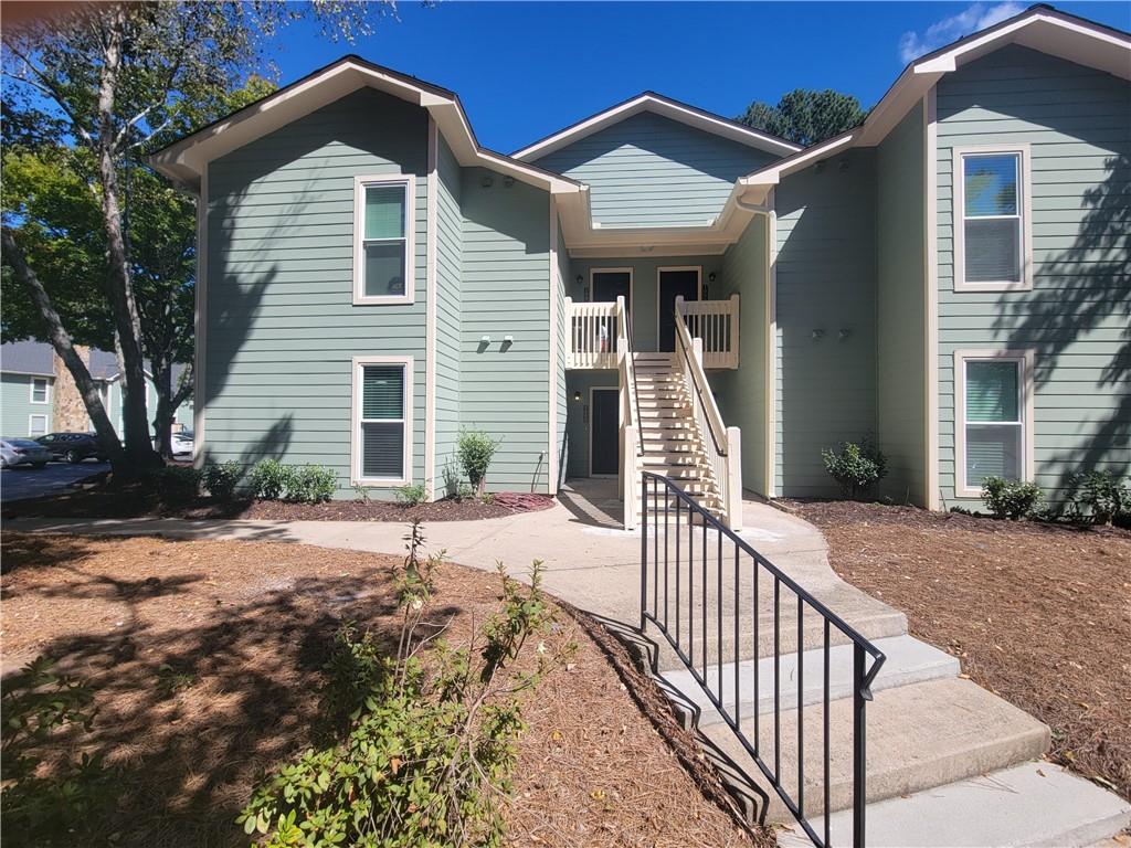 1000 Canyon Point Circle Roswell, GA 30076 - Photo 1 of 1 a view of a house with wooden fence and two windows