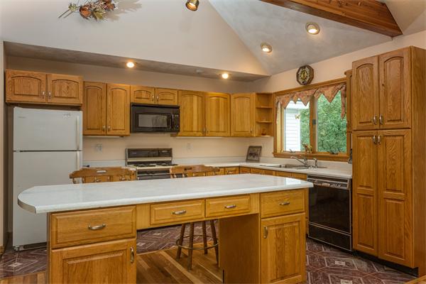 30 Coleman Road Groveland, MA 01834 - Photo 8 of 15 a kitchen with stainless steel appliances granite countertop a refrigerator a stove a sink and a microwave