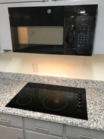 a kitchen with a stove and a microwave