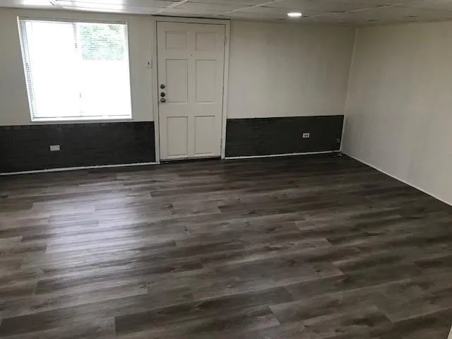 a view of a room with wooden floor
