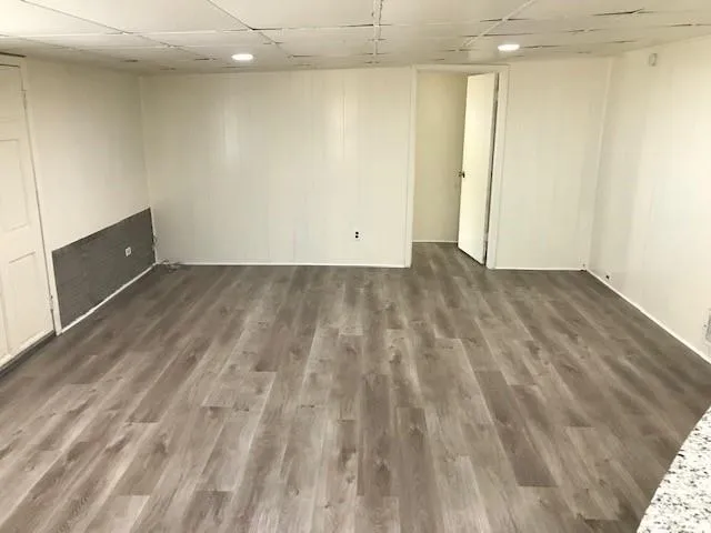 an empty room with wooden floor