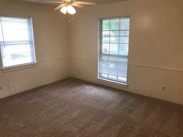 a bathroom with a granite countertop toilet a sink and a bathtub