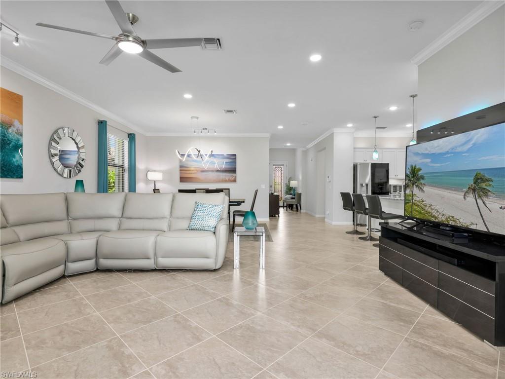4383 Bismark Way Naples, FL 34119 - Photo 21 of 49 Living Room, Dining Room, & Kitchen Leading to Front Entry Foyer with Stained Glass Door
