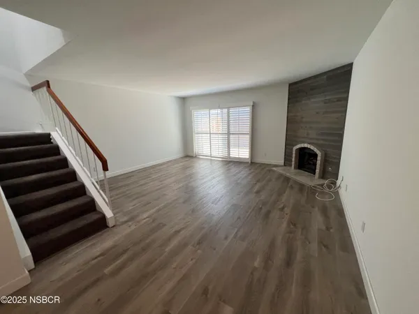 wooden floor in a hall with a window