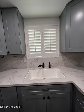a kitchen with a sink and cabinets