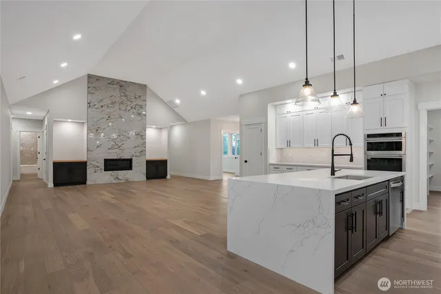 a kitchen with stainless steel appliances granite countertop a sink and a stove