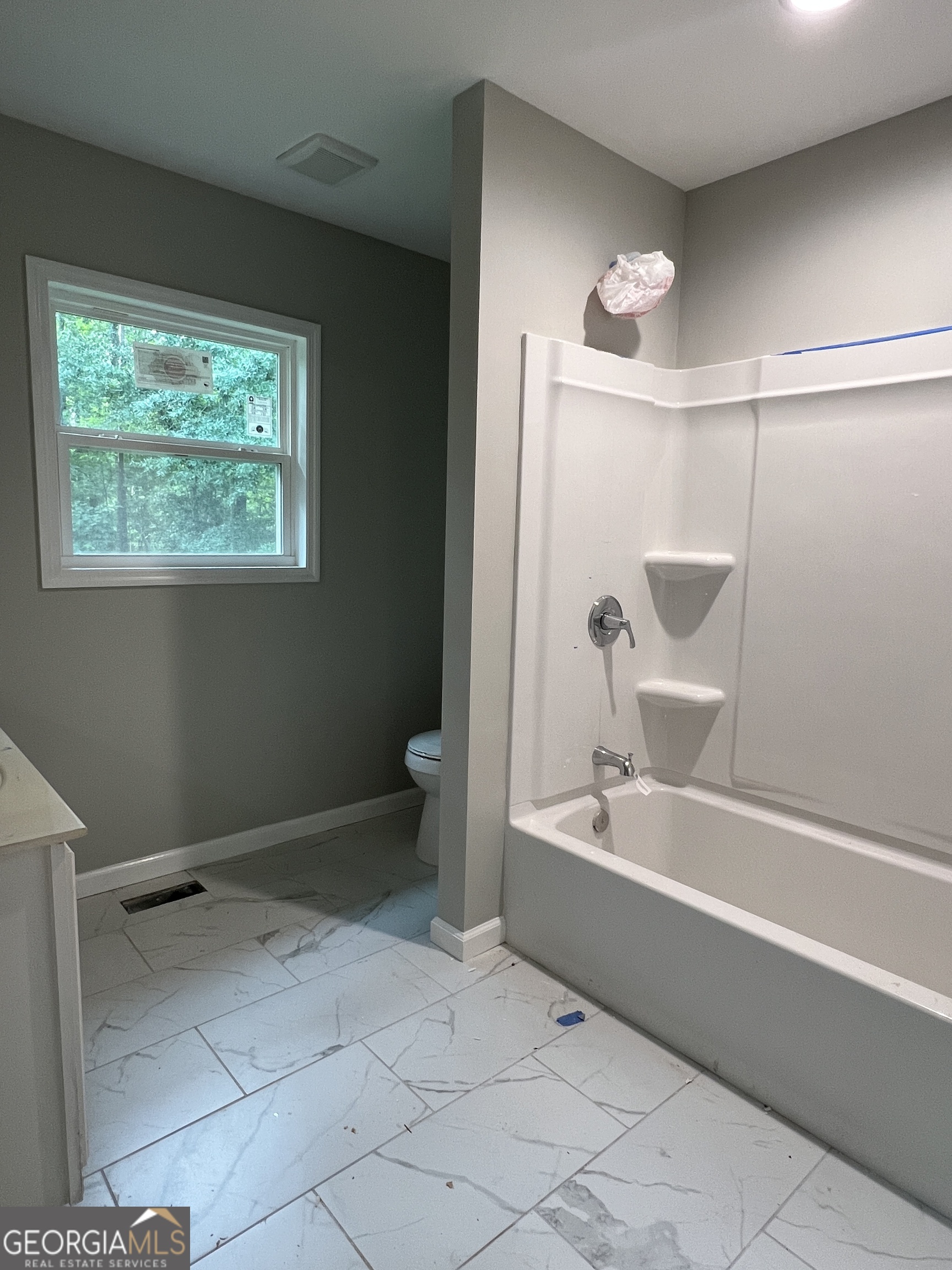 984 Plowshare Road Carrollton, GA 30117 - Photo 11 of 15 a bathroom with a bathtub and a shower