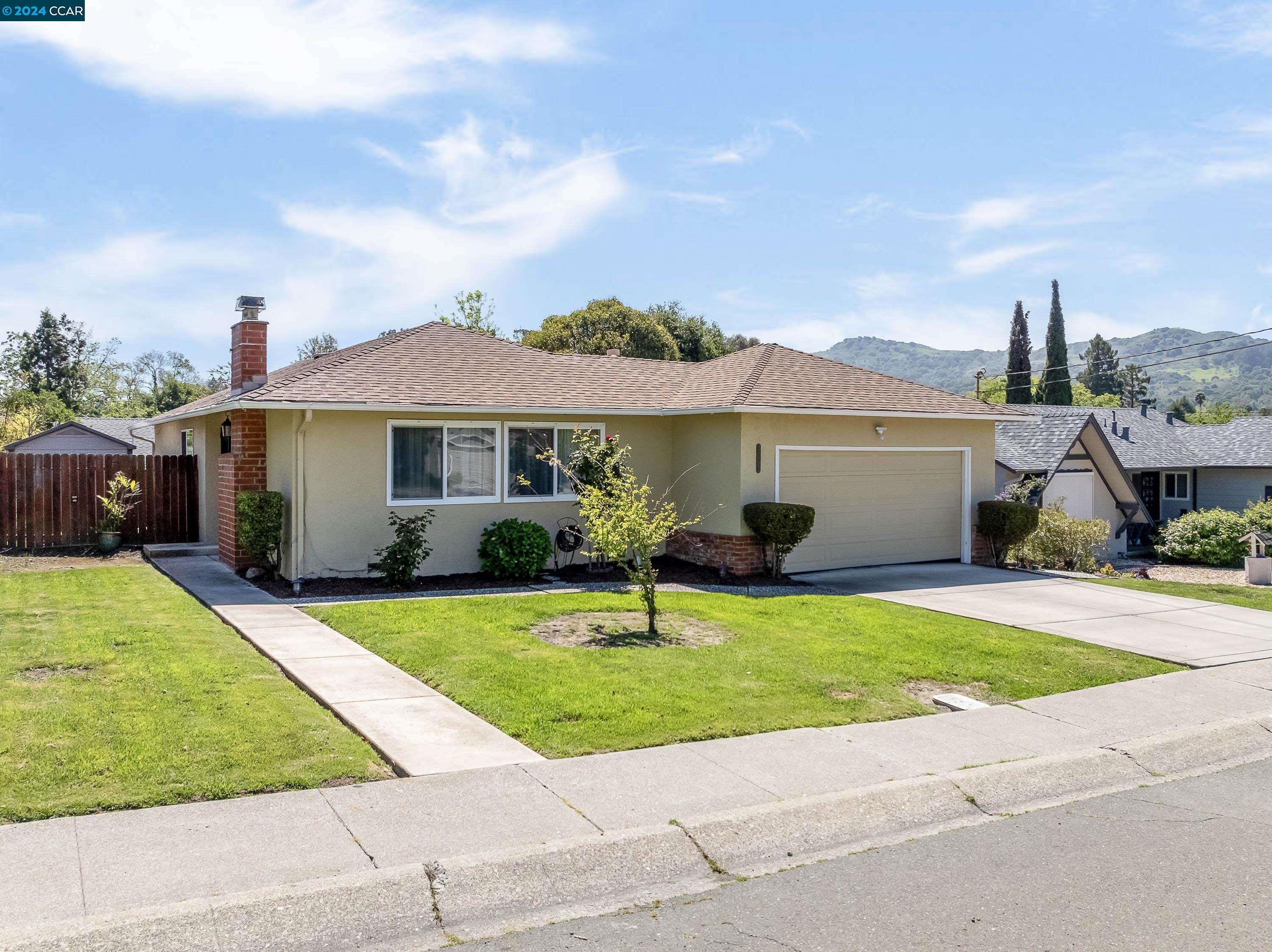 3052 May Road Richmond, CA 94803 - Photo 1 of 1 a front view of a house with a garden and yard