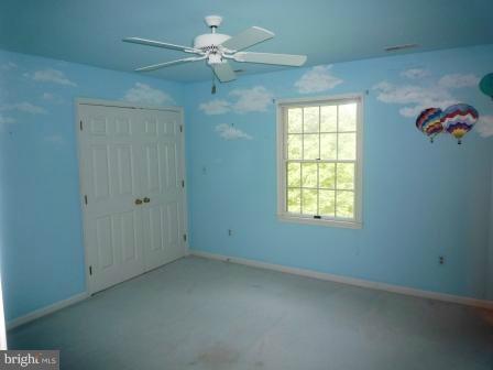 3610 Jackson Cabin Road Phoenix, MD 21131 - Photo 13 of 29 an empty room with a chandelier fan and windows
