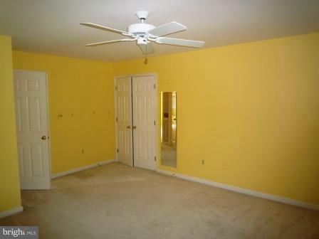 3610 Jackson Cabin Road Phoenix, MD 21131 - Photo 14 of 29 an empty room with a ceiling fan and a window