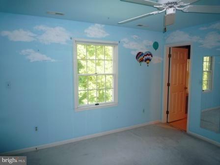 3610 Jackson Cabin Road Phoenix, MD 21131 - Photo 15 of 29 an empty room with a window and a ceiling fan