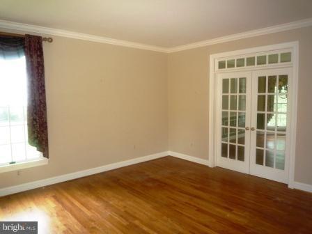3610 Jackson Cabin Road Phoenix, MD 21131 - Photo 4 of 29 a view of empty room with wooden floor and fan