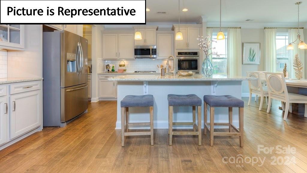 110 Saidin Lane Troutman, NC 28166 - Photo 11 of 48 a kitchen with dining table and chairs