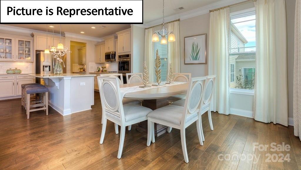 110 Saidin Lane Troutman, NC 28166 - Photo 13 of 48 a dining room with furniture and wooden floor
