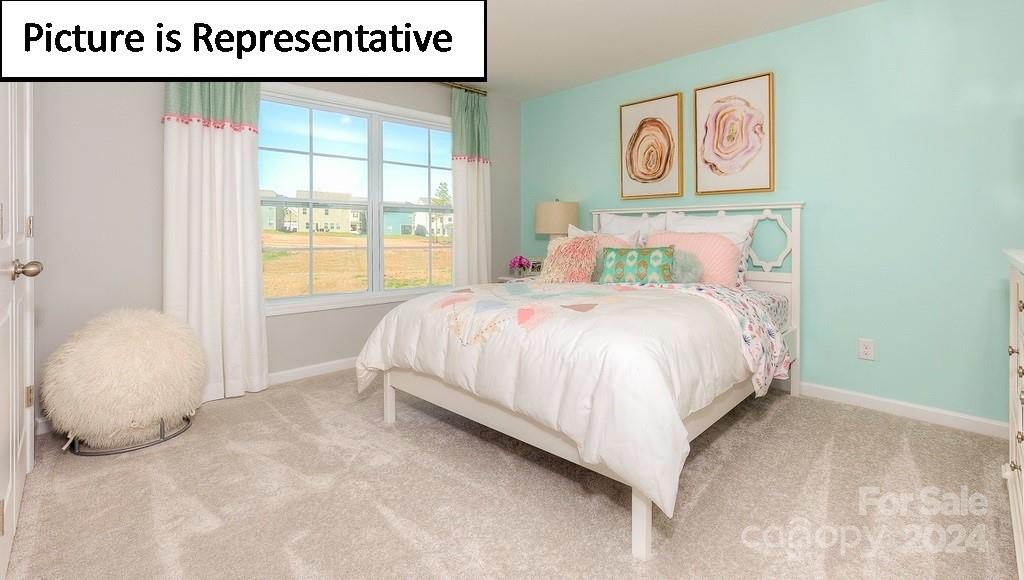 110 Saidin Lane Troutman, NC 28166 - Photo 35 of 48 a bedroom with a bed and a painting on the wall