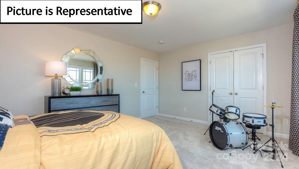 110 Saidin Lane Troutman, NC 28166 - Photo 37 of 48 a bedroom with a bed and a mirror