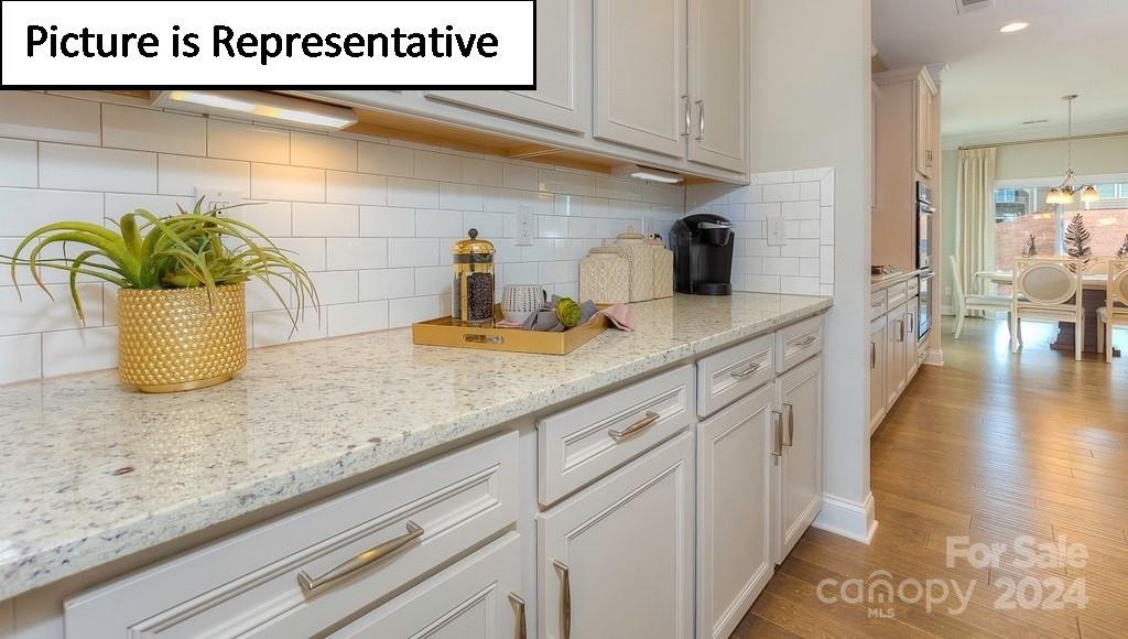 110 Saidin Lane Troutman, NC 28166 - Photo 8 of 48 a kitchen with a sink and a wooden floor