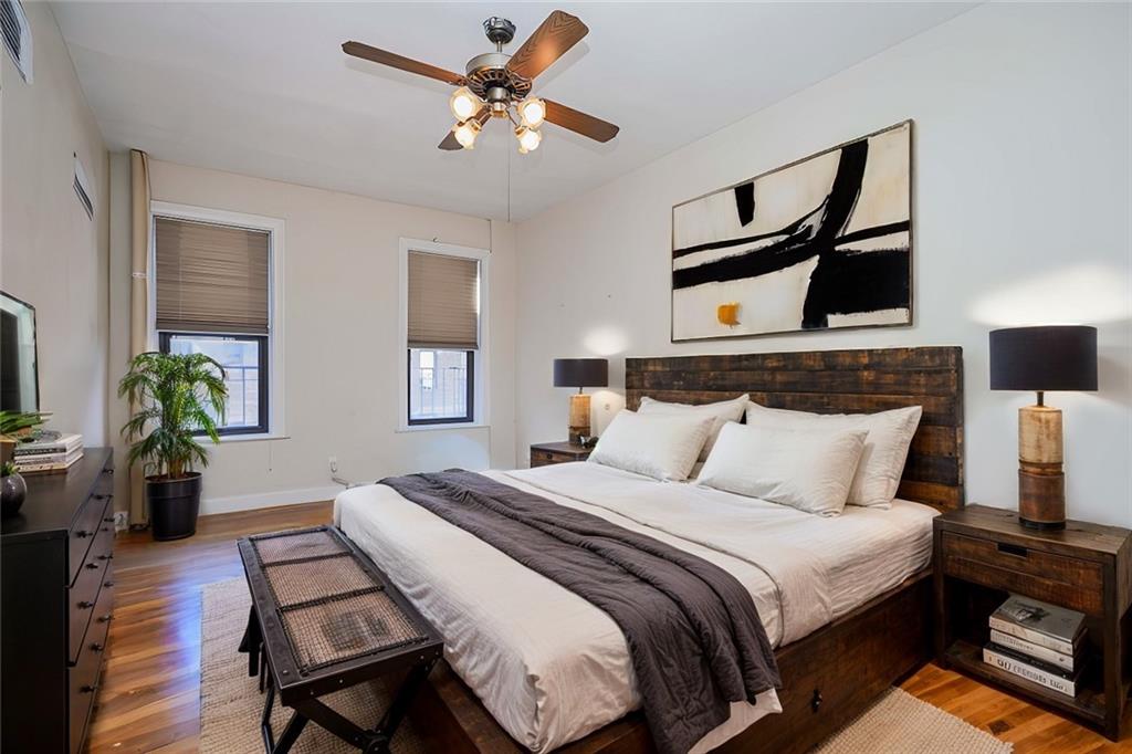 7101 Colonial Road, Unit L5I Brooklyn, NY 11209 - Photo 4 of 7 a bedroom with a bed and wooden floor