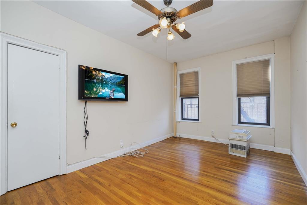 7101 Colonial Road, Unit L5I Brooklyn, NY 11209 - Photo 6 of 7 a view of empty room with wooden floor and fan