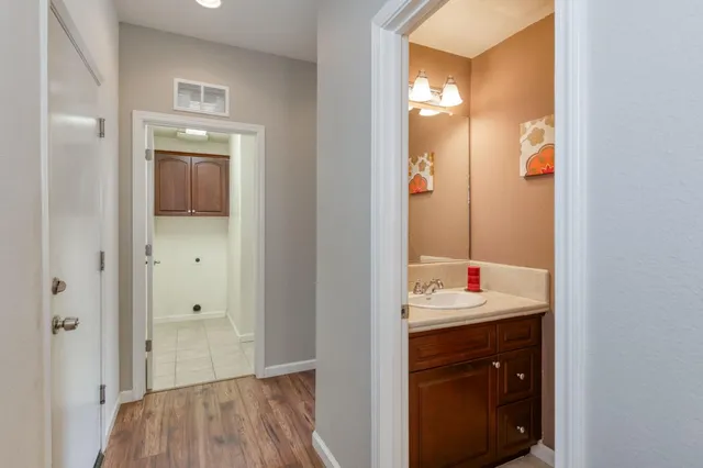 a bathroom with a granite countertop sink and a mirror