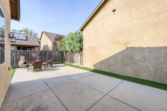 a view of a house with backyard and sitting area