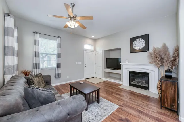 a living room with furniture a window and a fireplace