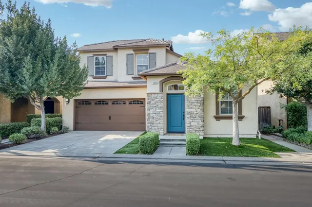 a front view of a house with a yard and garage