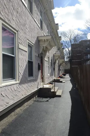a view of a house with backyard and sitting area