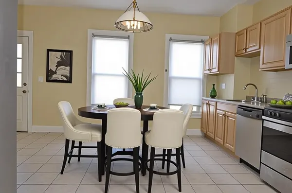 a view of a dining room with furniture a chandelier and wooden floor