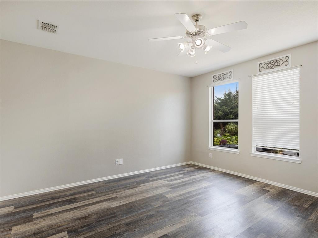 2009 Cooper Ridge Lane Heartland, TX 75126 - Photo 13 of 40 Unfurnished room with dark wood-type flooring and a ceiling fan