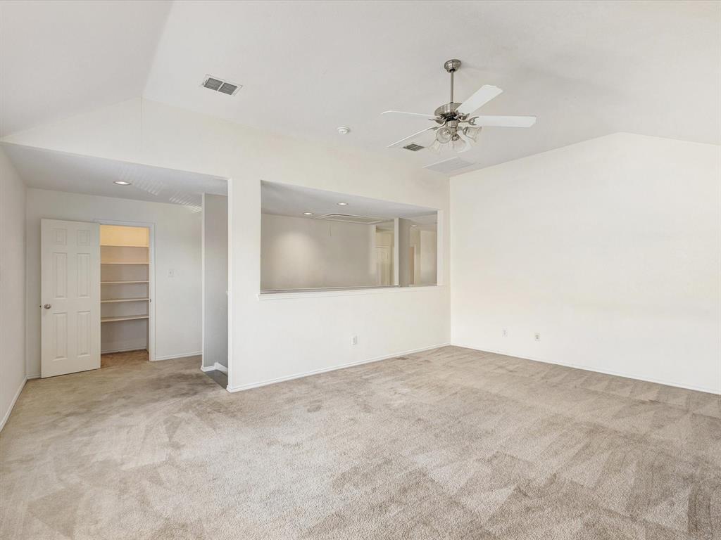 2009 Cooper Ridge Lane Heartland, TX 75126 - Photo 21 of 40 Unfurnished room featuring lofted ceiling, light carpet, and a ceiling fan