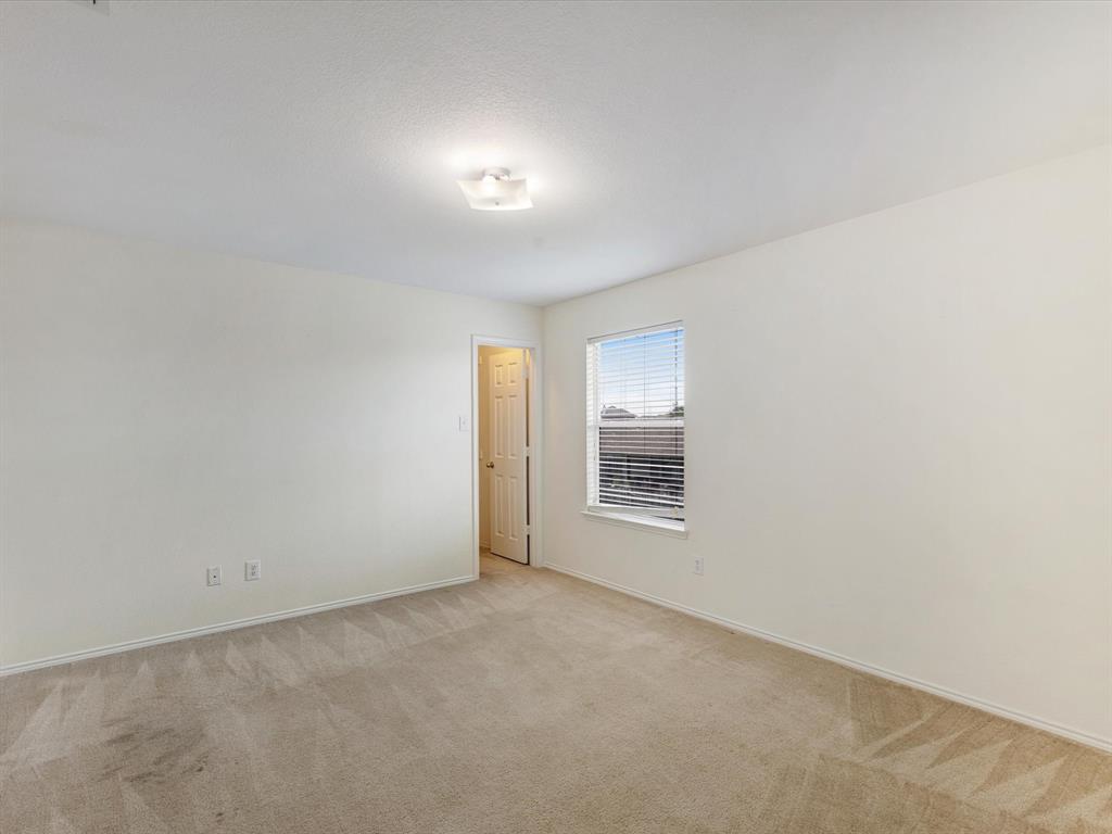2009 Cooper Ridge Lane Heartland, TX 75126 - Photo 23 of 40 Unfurnished room featuring carpet floors and baseboards